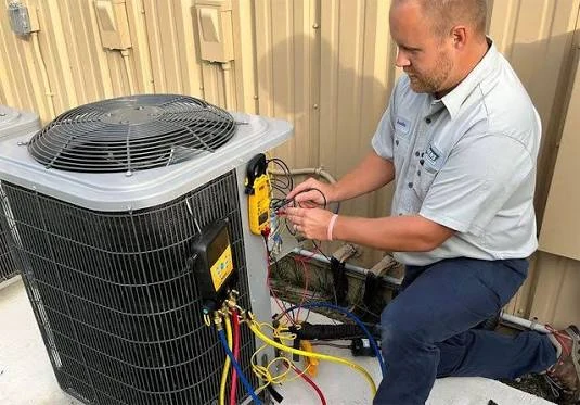 Technician checking an outdoor air conditioning system